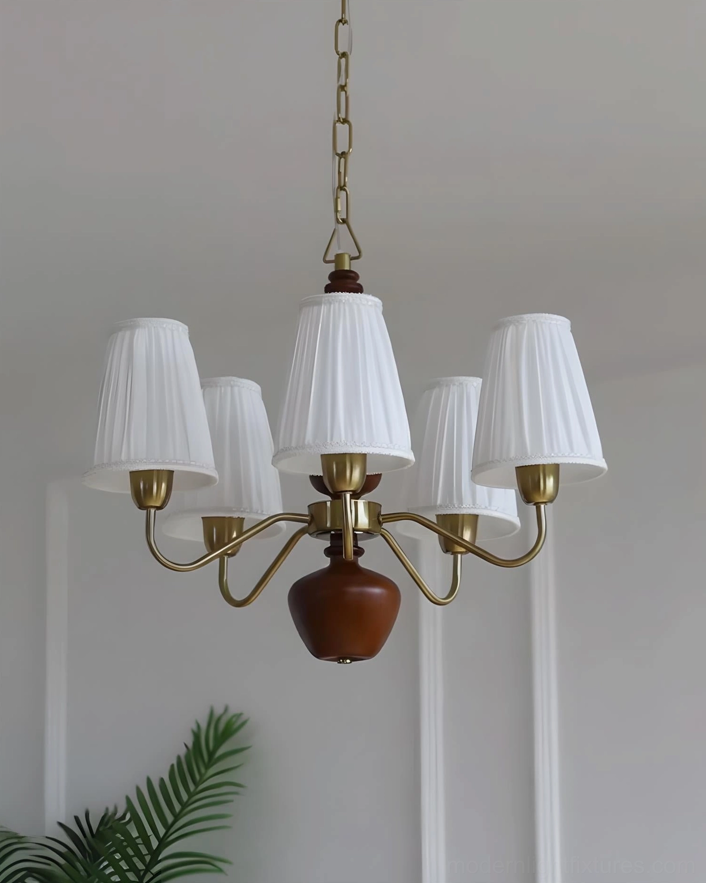Cadenza fabric chandelier studio shot - brass frame, dark brown wood base, white pleated shades