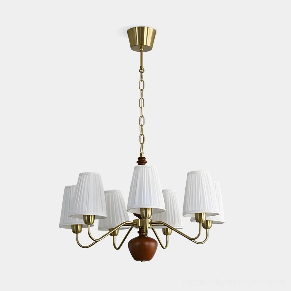 Cadenza fabric chandelier with brass frame, walnut wood center, and white pleated shades - front studio view