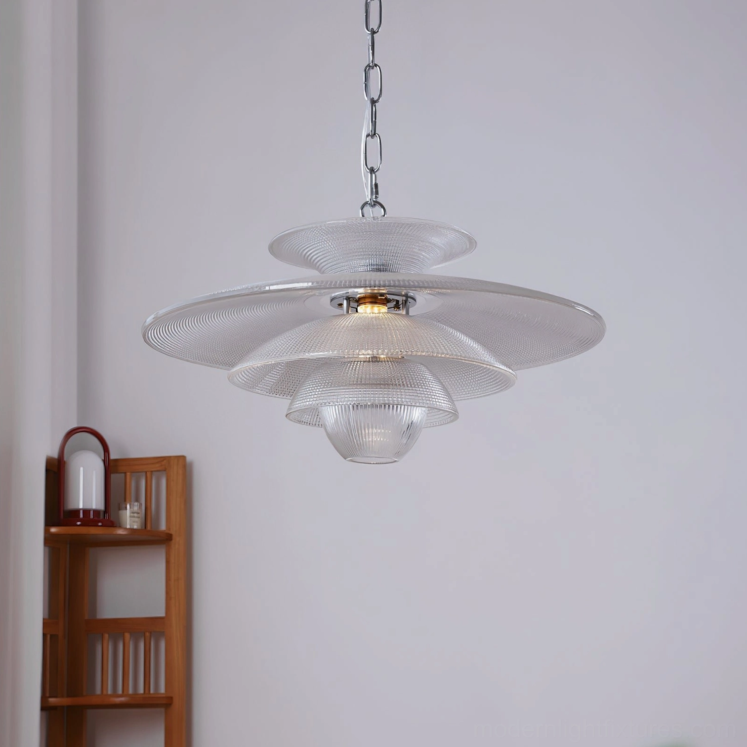 Cadenza tiered pendant light illuminated showing inner bulb and multi-layer ribbed glass design, front view