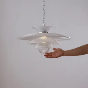 Cadenza modern glass pendant fixture showing ribbed glass tiers and adjustable chrome hanging chain with hand scale reference