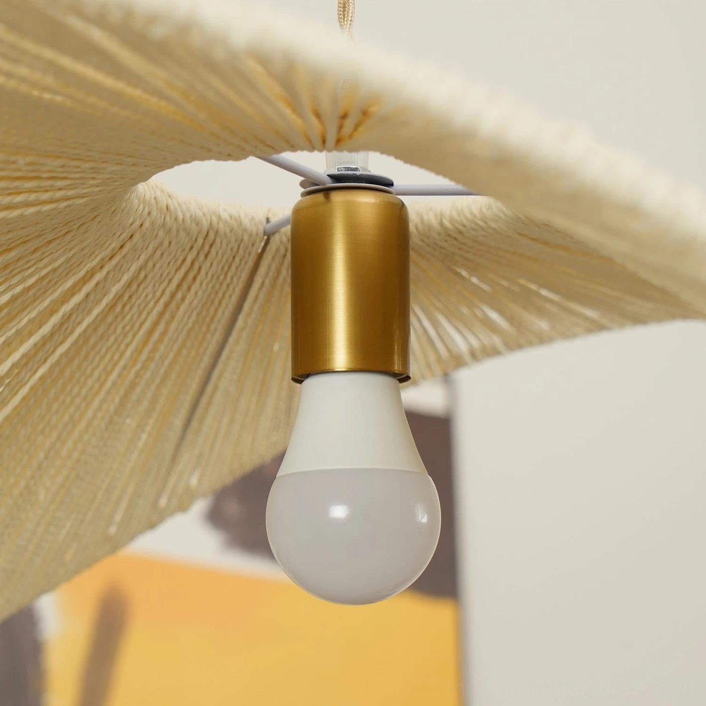 Brown woven rope straw hat pendant light creating warm atmospheric lighting in hospitality cafe setting