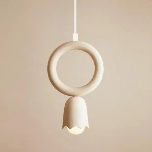 Cairn pendant lamp close-up showing exposed E27 bulb beneath scalloped ceramic shade detail in warm studio lighting