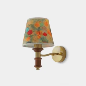 Calantha wall sconce with floral pleated fabric shade, brass-tone iron arm and walnut-tone wood accents, studio front view