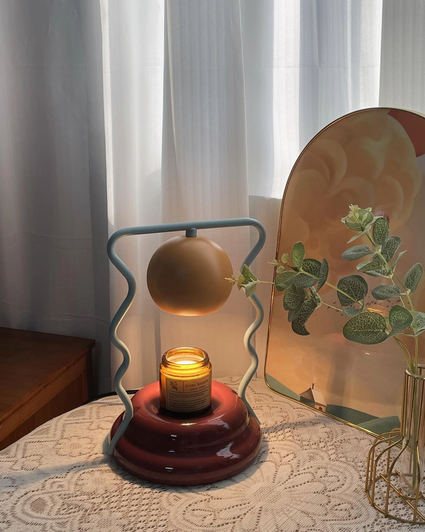 Caldas Candle Warmer Lamp with scented candle lit - modern flameless candle warmer in home setting