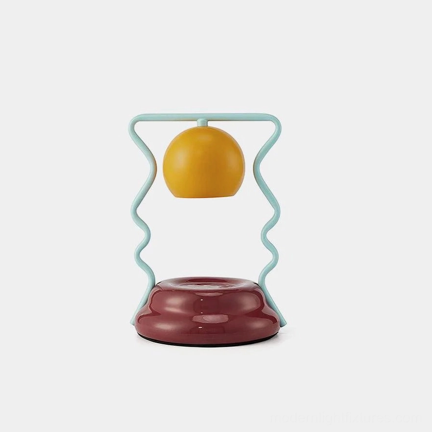 Caldas Candle Warmer Lamp in mint green, tan, and wine red on white background - modern artistic table light