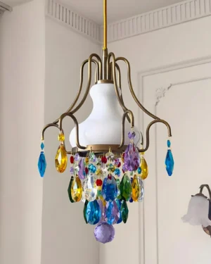 Caldira vintage crystal pendant chandelier - three-quarter angle showing white opaline glass shade, antique brass frame, and colored crystal drops