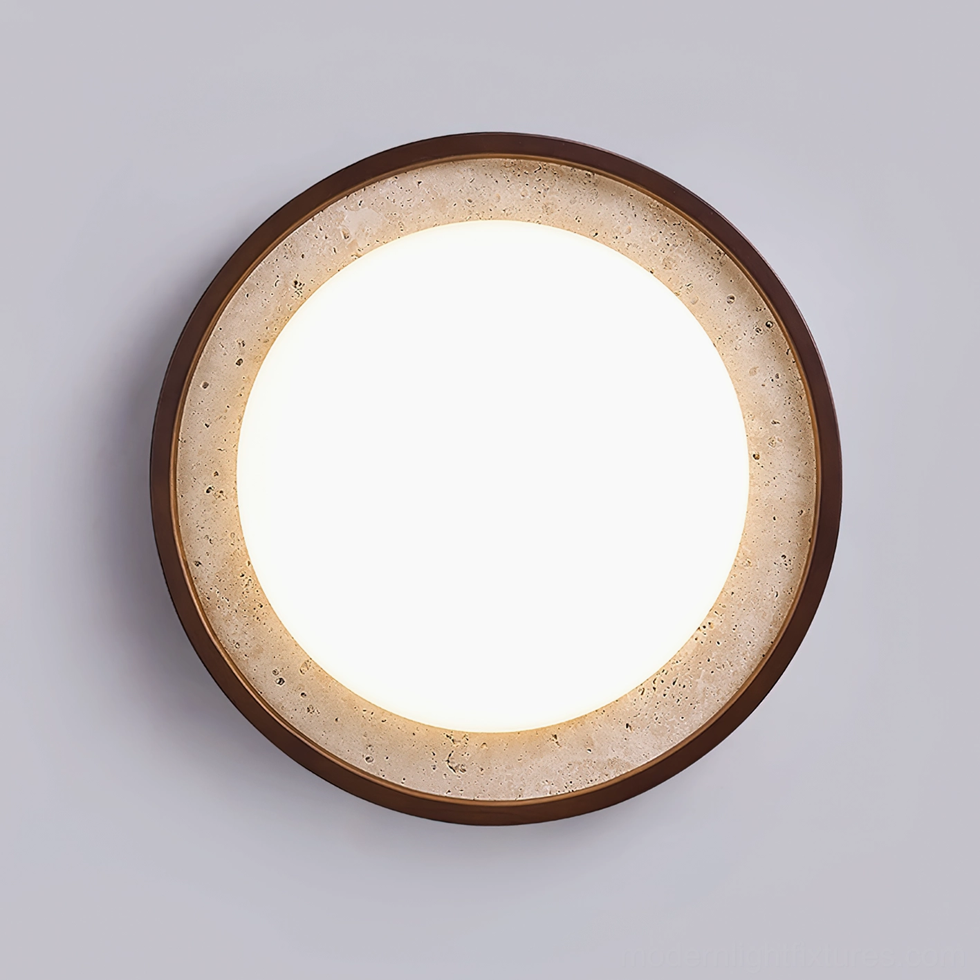 Caldo flush mount ceiling lamp, close-up detail showing speckled travertine border and warm light emission
