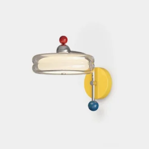 Calixo modern wall sconce with colorful retro pop art design, front close-up view showing chrome backplate and jewel-like glass shade accents against white studio background