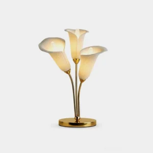 Calla lily table lamp with gold metal base and ribbed ceramic shades on minimalist studio background