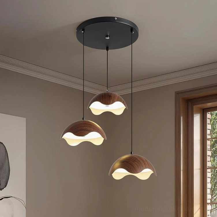 Callan 3-head round pendant light with black metal frame and sculptural wood shades in modern living room