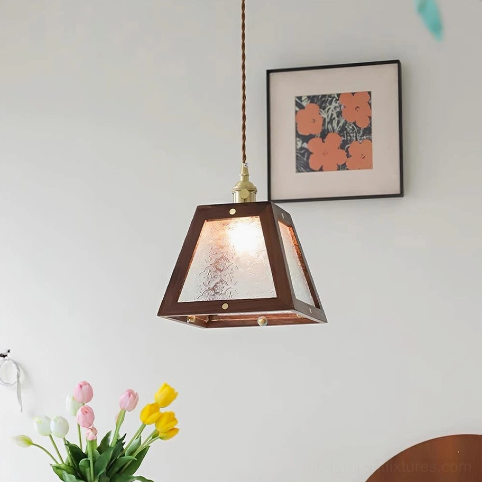 Calvi pendant light with clear glass shade and walnut wood frame, showing transparent design