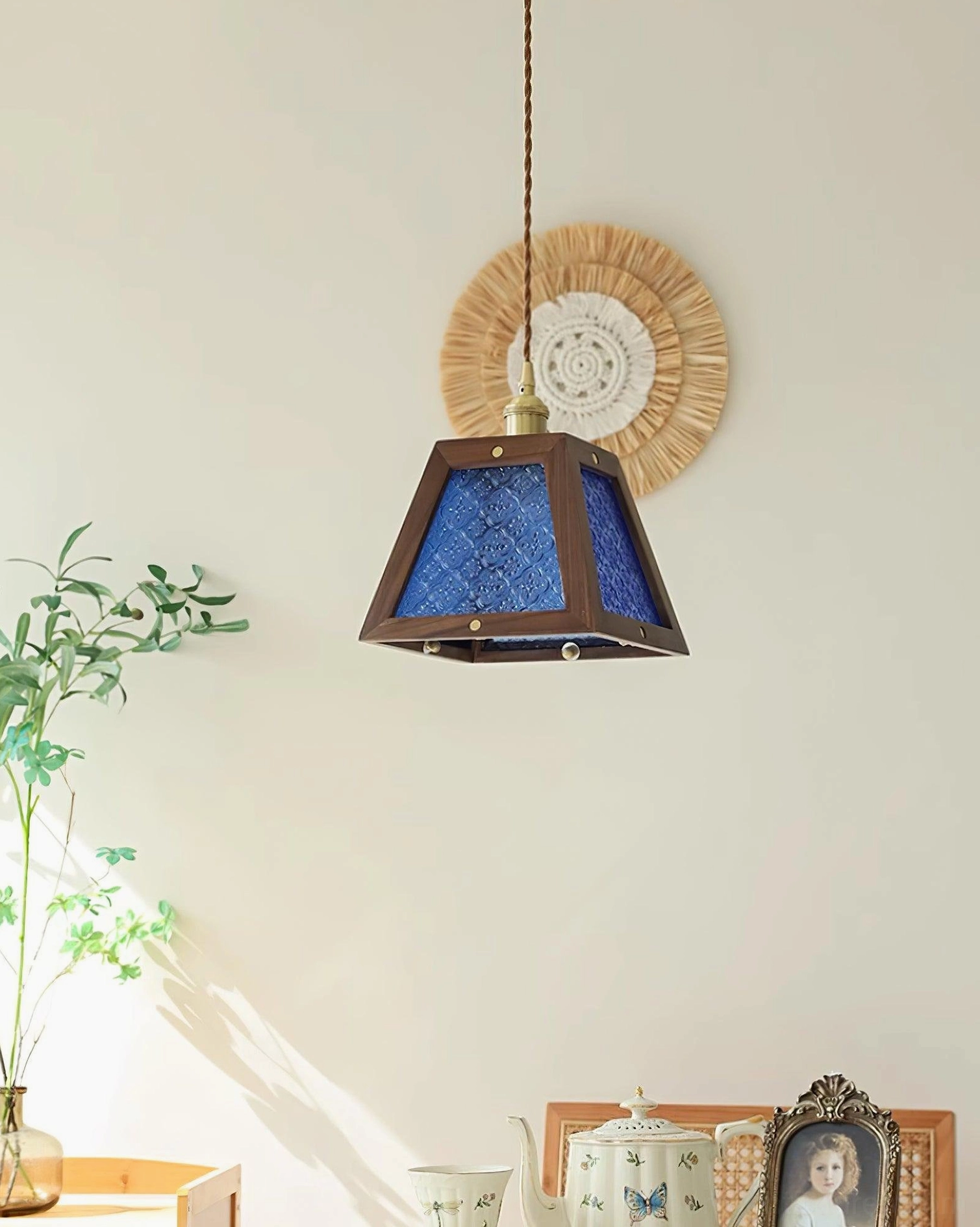Calvi pendant light showing complete assembly with trapezoid glass shade and wood frame construction