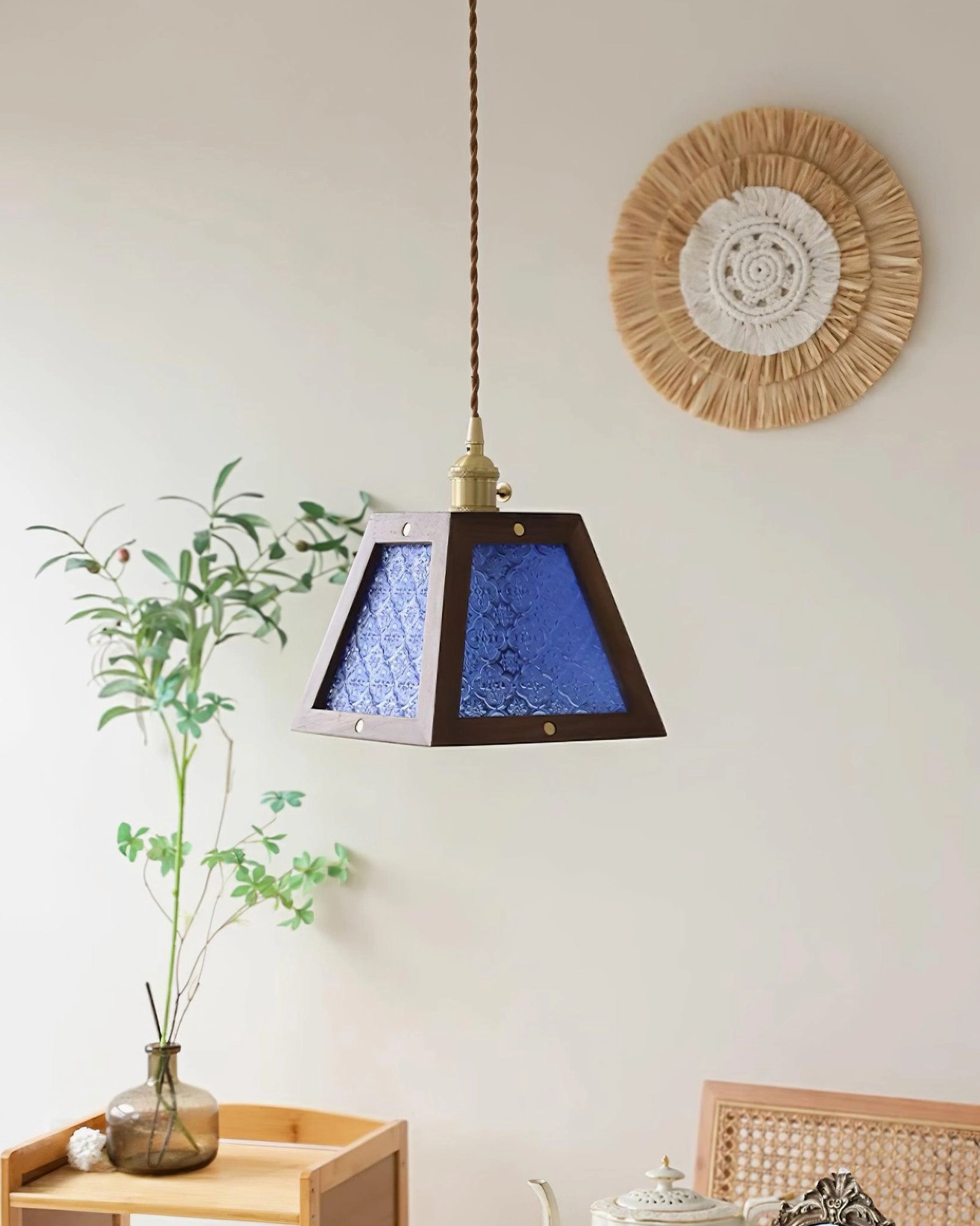Calvi pendant light fixture in eclectic interior space with decorative wall and botanical elements