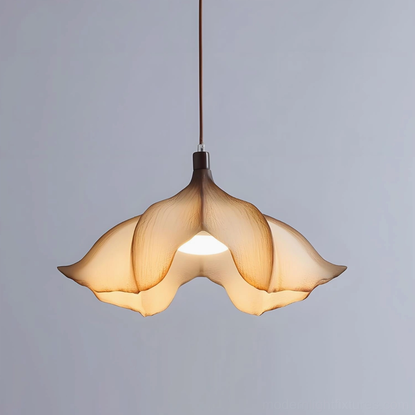 Calysa modern pendant fixture showing brown metal frame with beige PETG shade and gradient amber tinting effect