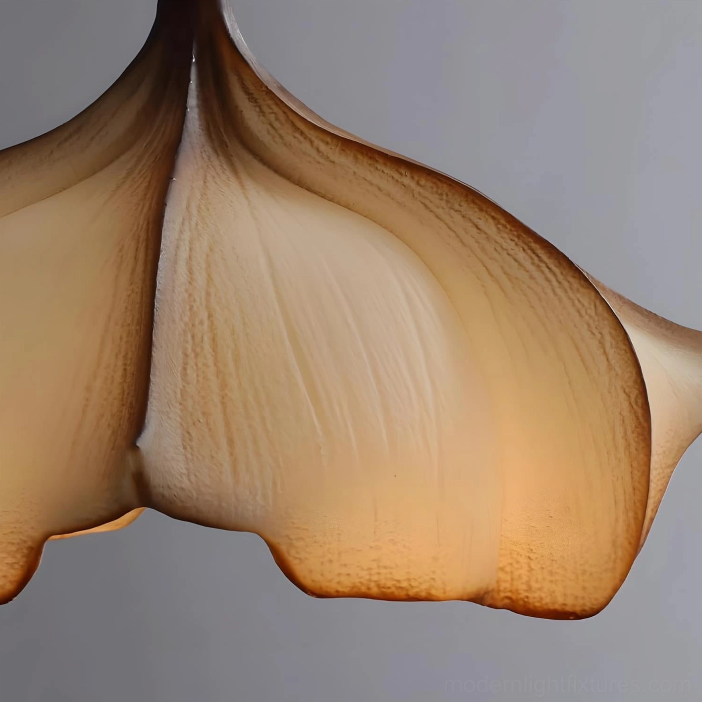 Calysa organic petal pendant lamp hanging at optimal dining height with warm contemporary interior styling