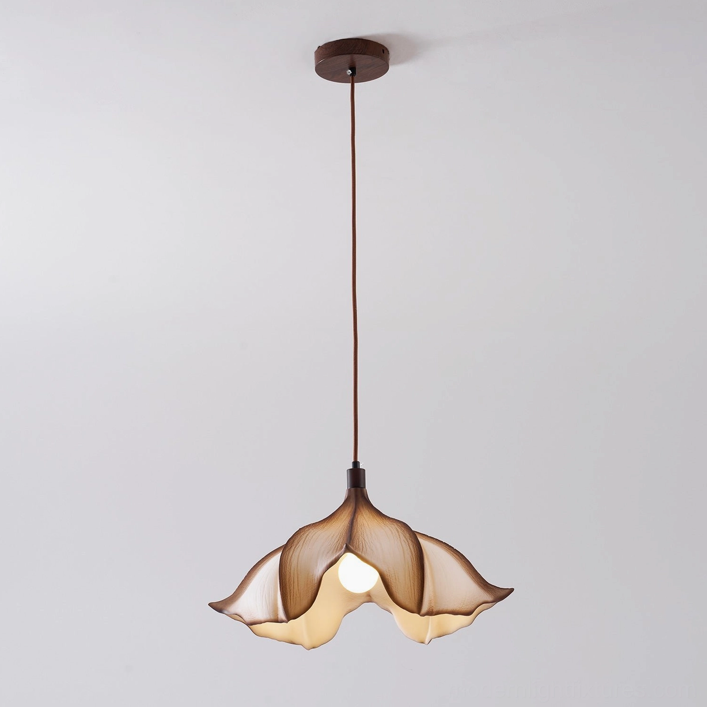 Calysa sculptural petal pendant light in transitional interior design setting bridging traditional and contemporary aesthetics
