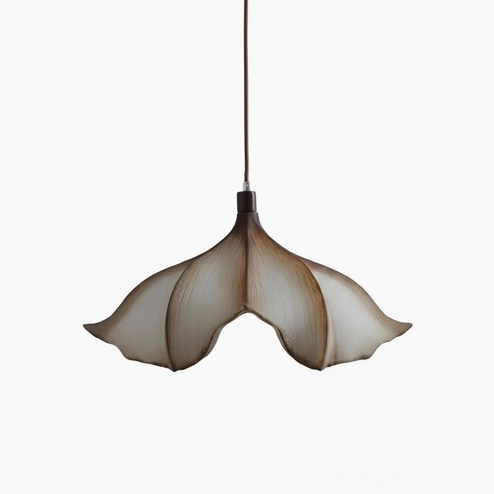 Calysa sculptural petal pendant light in studio product photography, highlighting curved PETG petal form and warm ivory-to-amber gradient tint