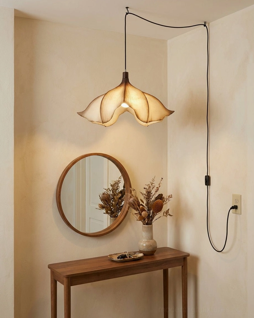 Calysa plug-in petal pendant light positioned above wooden vanity console in small bedroom corner, providing warm directional accent light