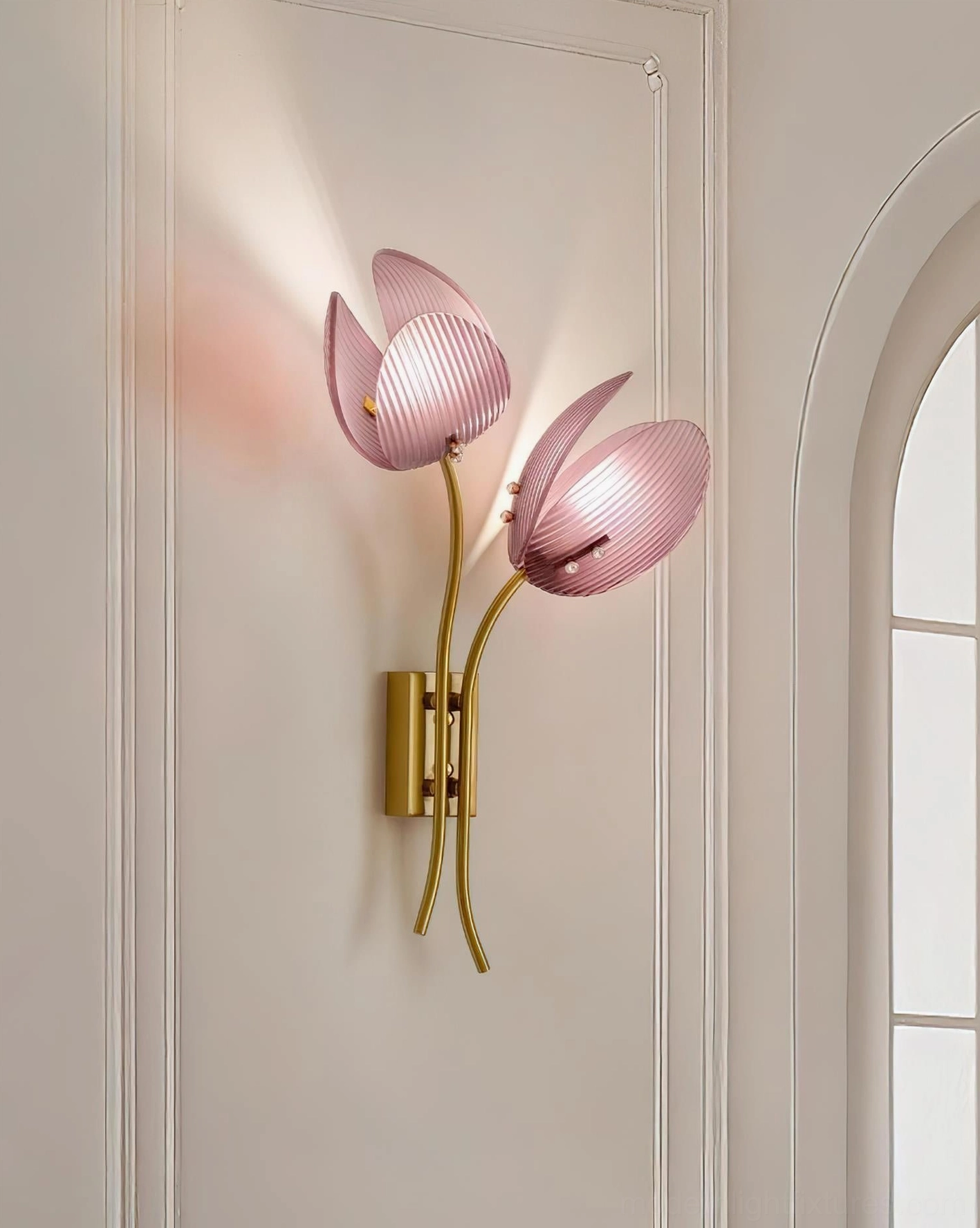 Calyssa dual tulip wall lamp mounted on neutral off-white wall near arched architectural trim, contemporary installation