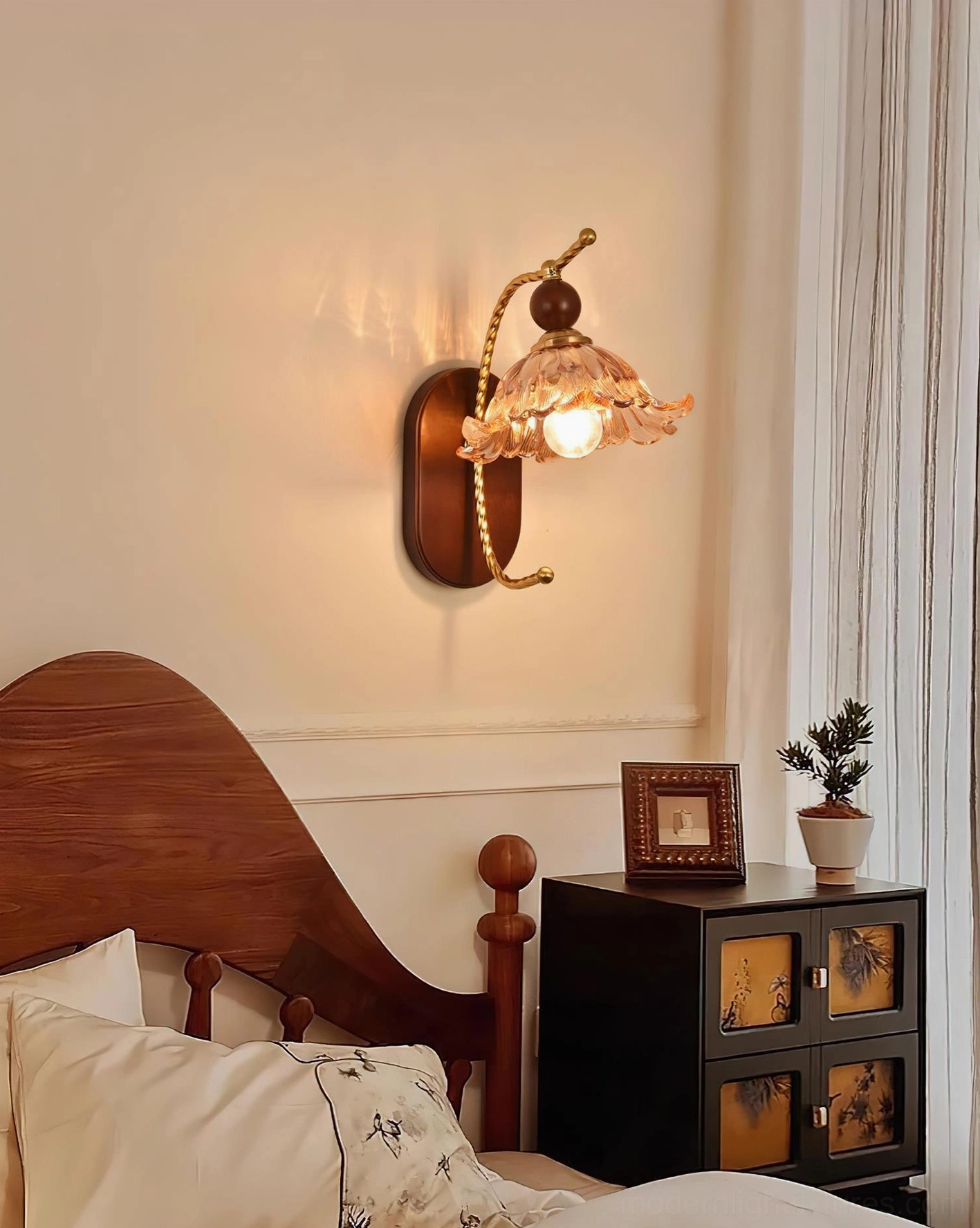 Calyx botanical wall sconce detail shot showing ruffled glass shade texture and brass arm craftsmanship