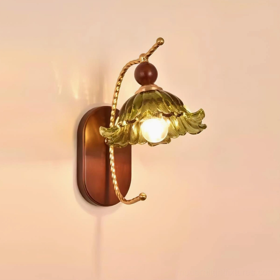 Calyx wall sconce botanical design glass shade creating soft diffused lighting effect on wall