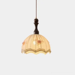Camélia fabric pendant light with pleated beige shade and floral appliqué, front studio view