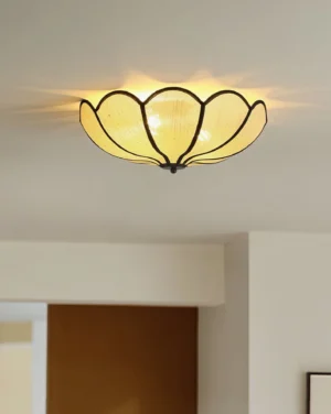 Modern camellia ceiling light fixture installed in hallway with warm ambient lighting, low-angle view