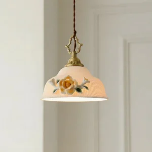 Illuminated camellia grace ceramic pendant lamp showing warm light through textured porcelain dome with brass hardware