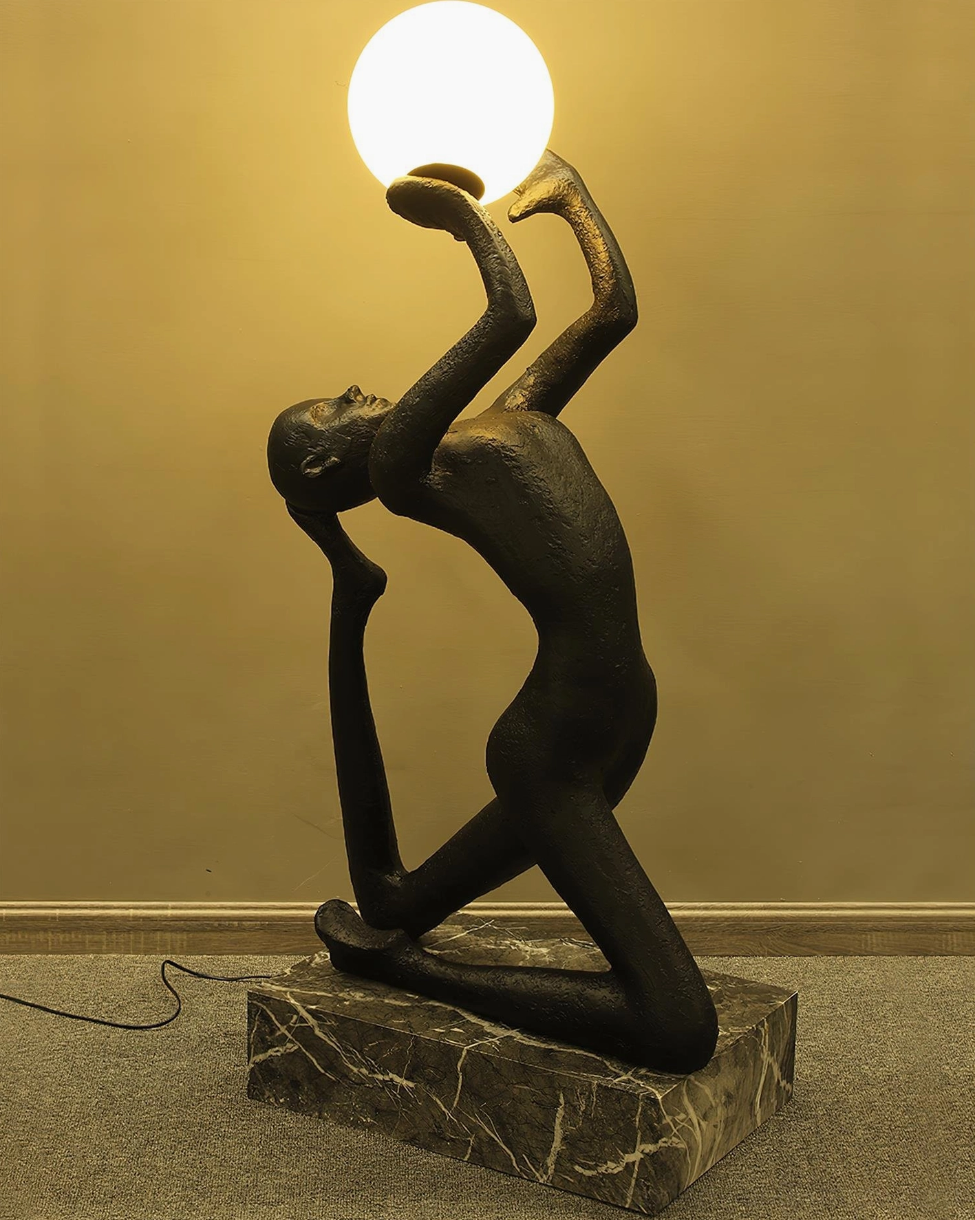 Close-up detail of Camilla floor lamp base and kneeling figure sculptural form