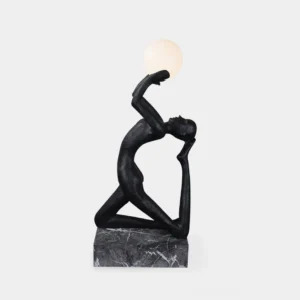Camilla kneeling sculpture floor lamp front view with matte black resin figure and frosted glass orb on marble base