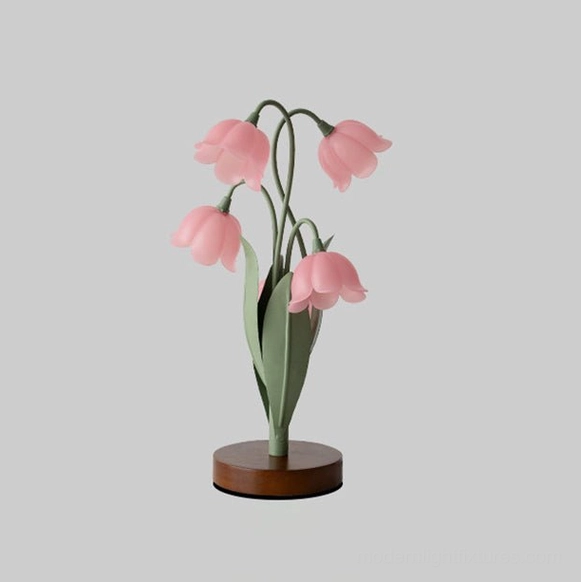 Campelle pink bell-flower lamp model A with switchable color temperature settings on bedroom desk in home interior