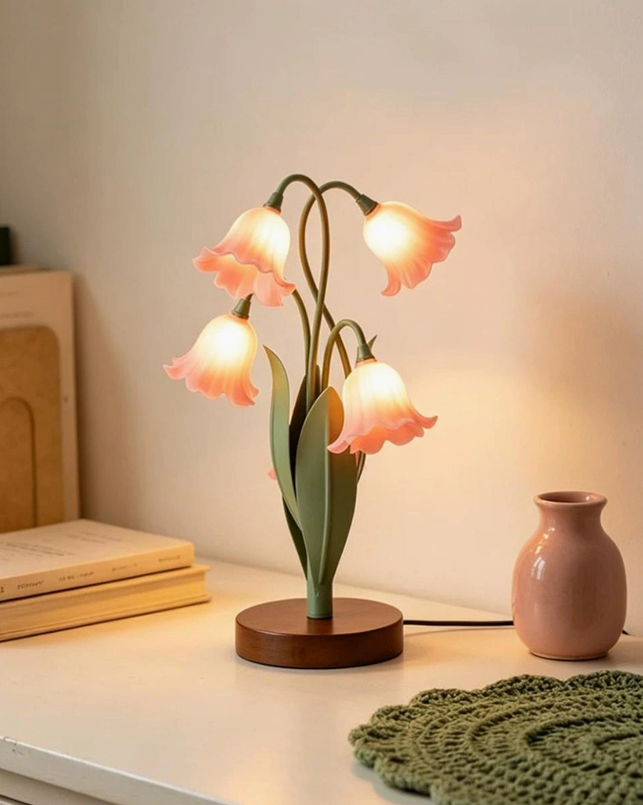 Campelle pink tulip lamp on bedroom bedside desk with warm glowing light, vintage framed art and rustic home decor background