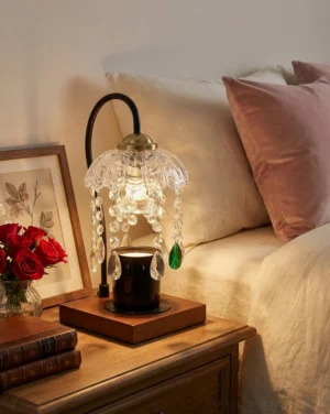 Flame-free candle warmer lamp on bedroom nightstand with black pillar candle, vintage glam style with warm ambient light
