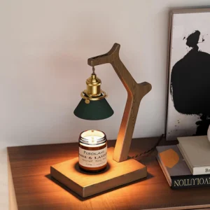 Candle warmer table lamp on bedroom nightstand with scented candle, books and wall decor