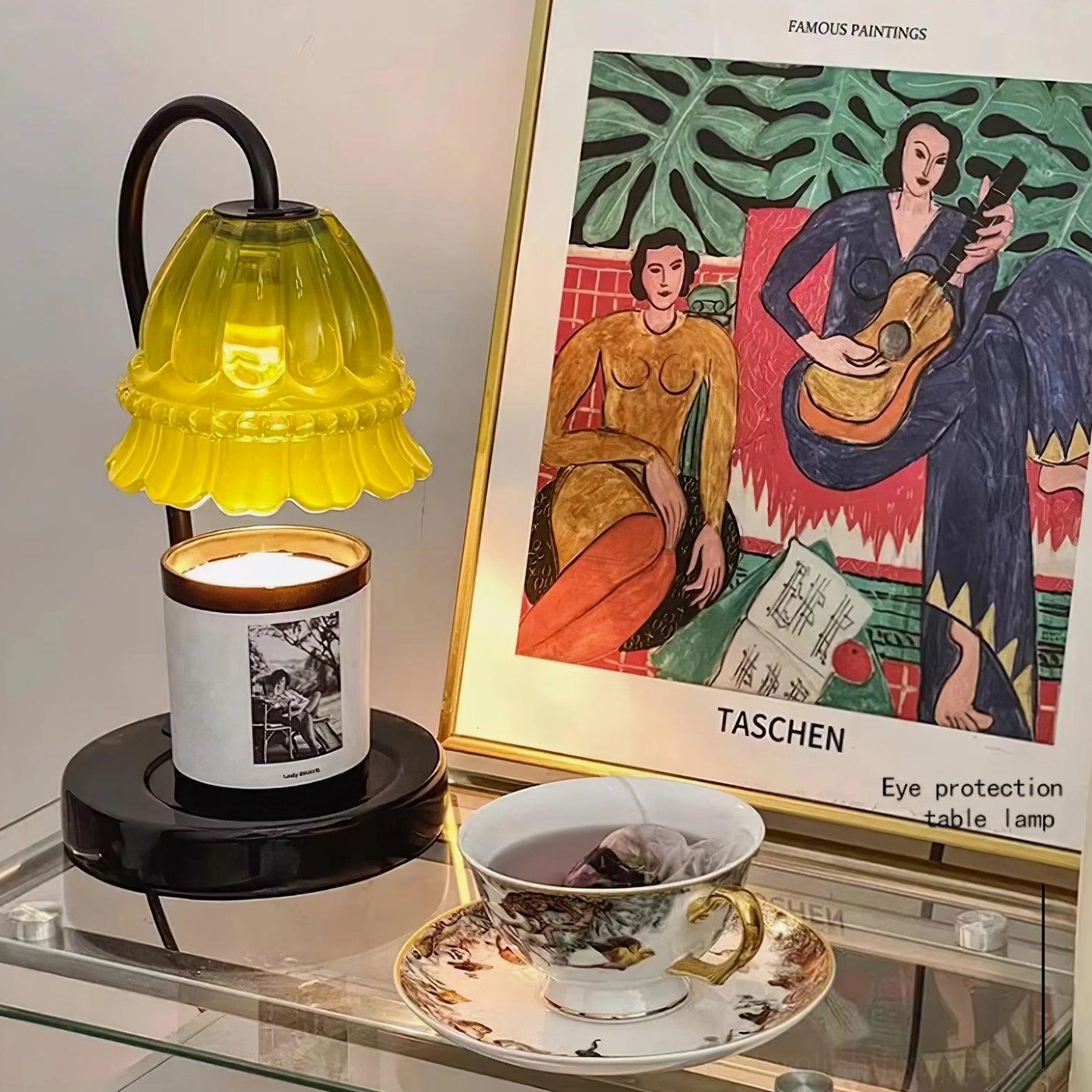 Contemporary candle warmer lamp on styled bookshelf with home accessories