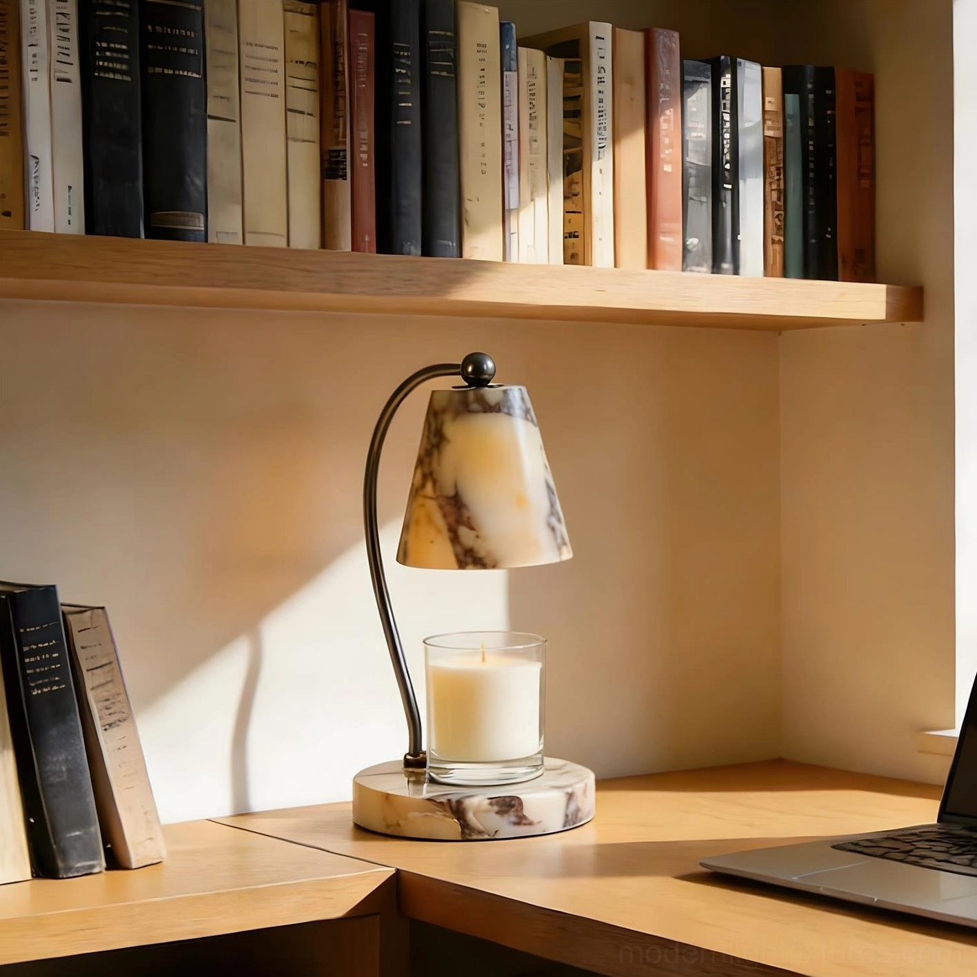 Marble candle warmer lamp placed on home office desk beside laptop and wooden bookshelf