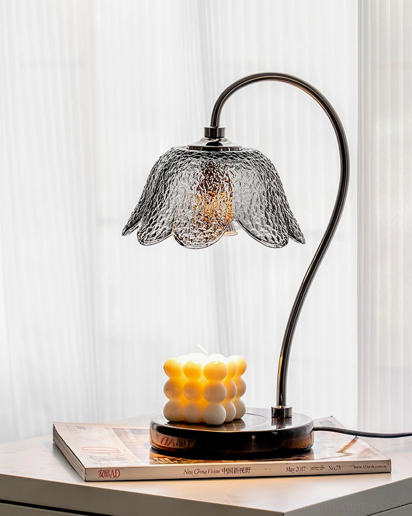 Black marble candle warmer lamp detailed view of curved metal arm and textured glass shade