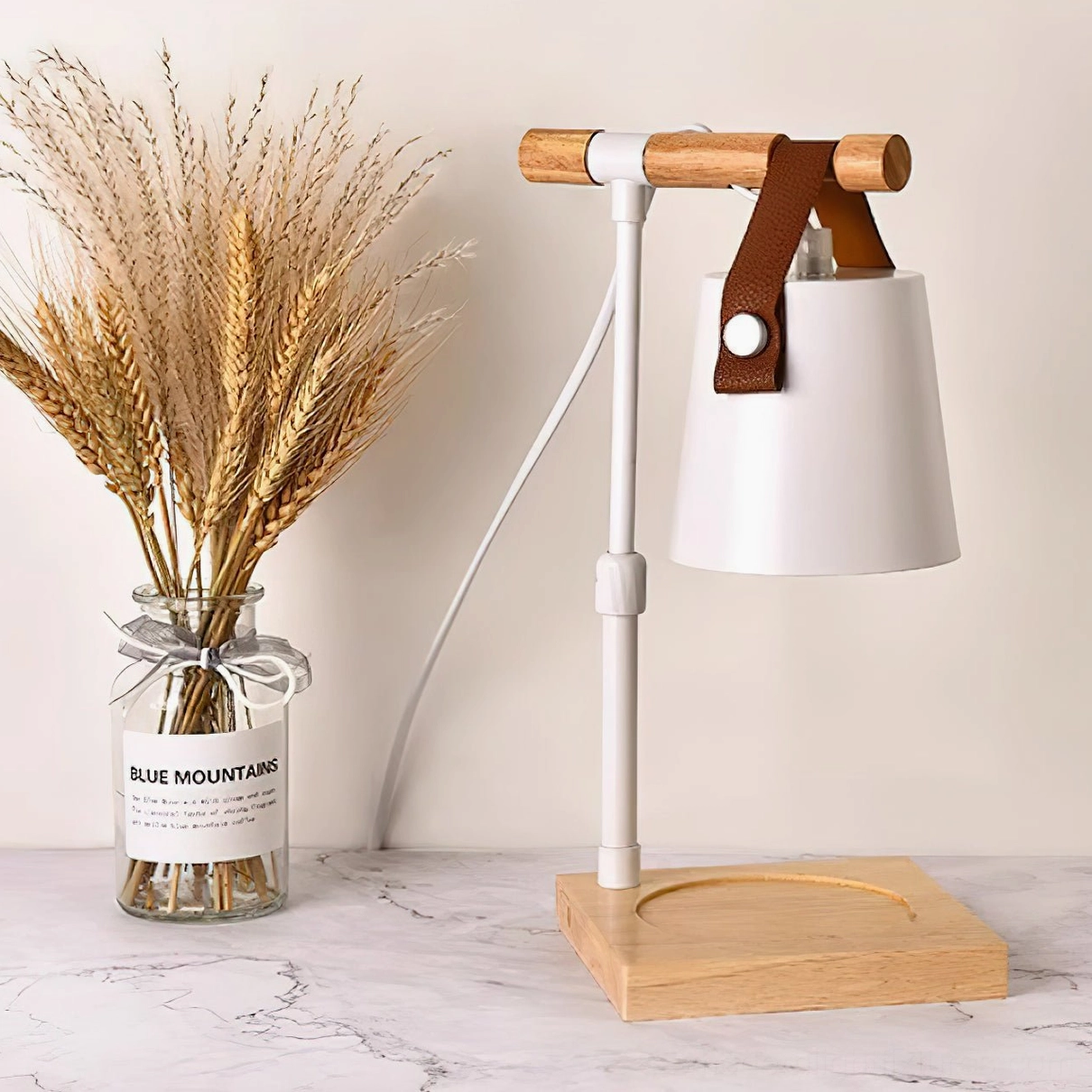 Candle warmer lamp paired with scented candles in coordinated styling, living room ambiance scene
