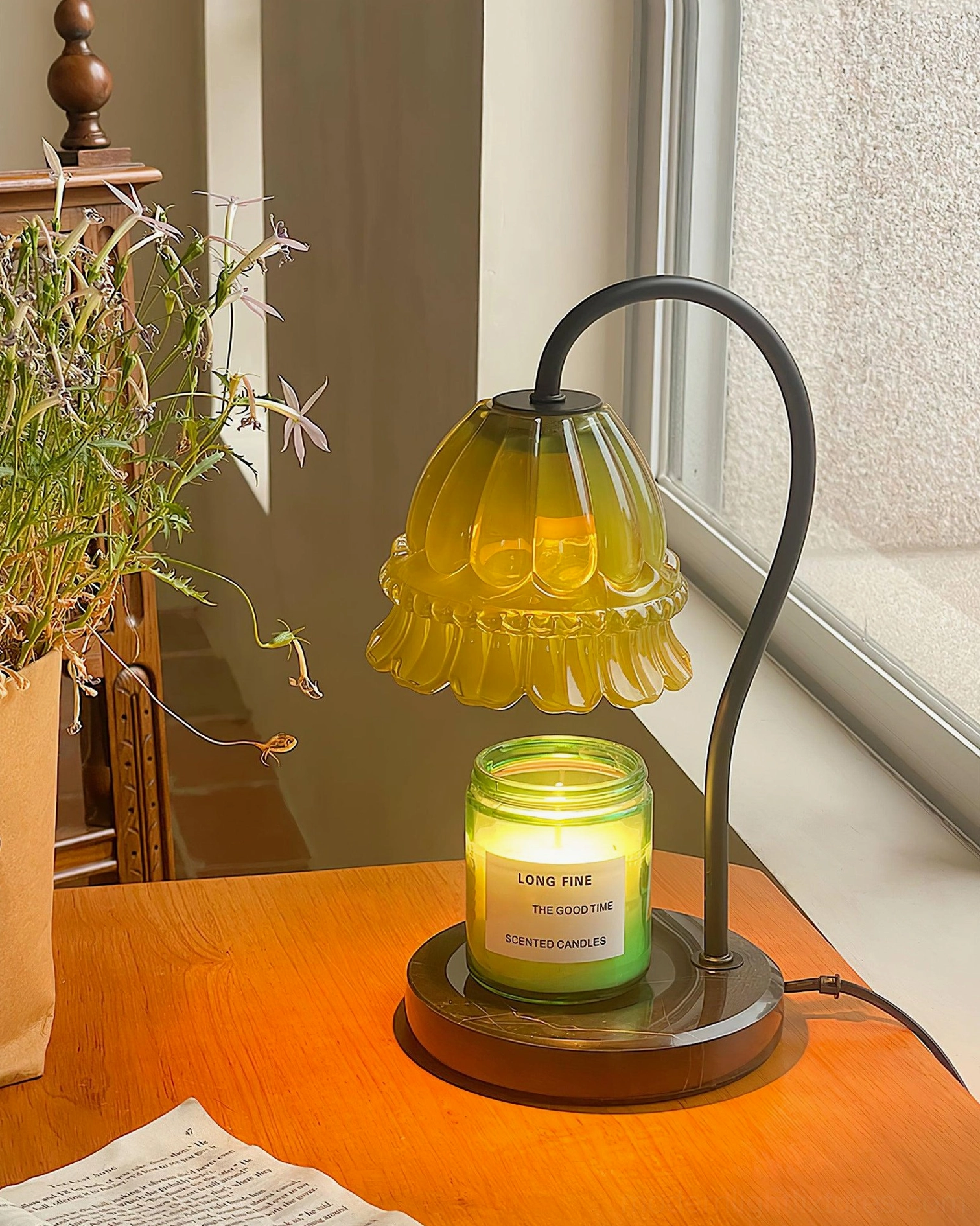 Overhead top-down view of illuminated candle warmer lamp in bedroom setting