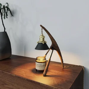 Black walnut wood candle warmer lamp side profile with lit halogen heat, scented candle on wooden table