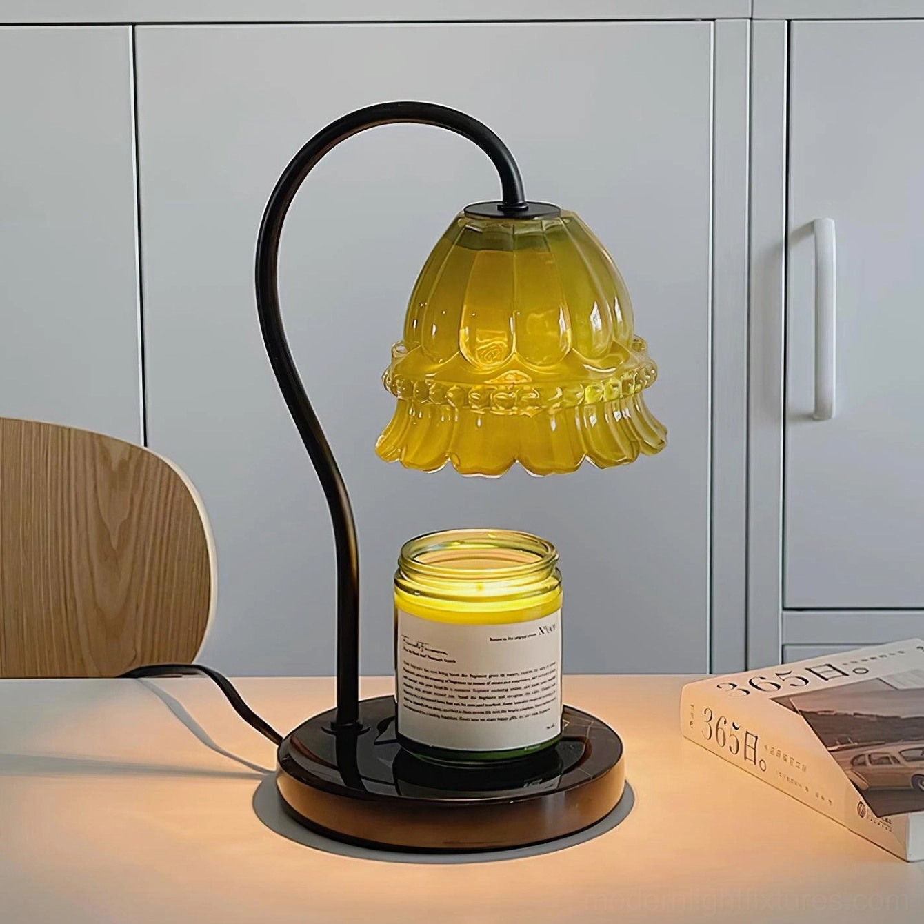 Contemporary candle warmer lamp on home office desk with elegant cabinet backdrop