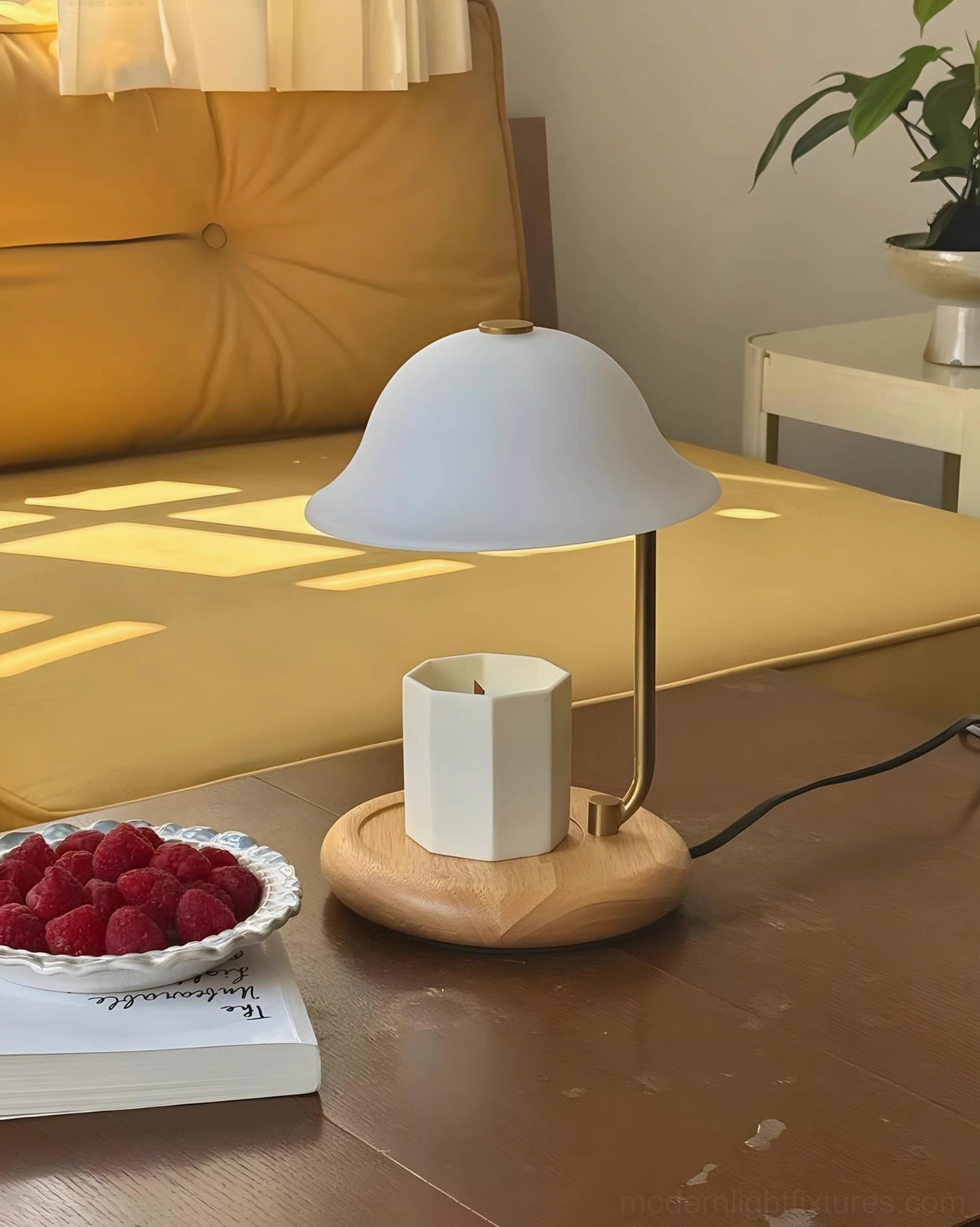 Contemporary table lamp with candle warming function displayed in sunlit interior with natural wood tones