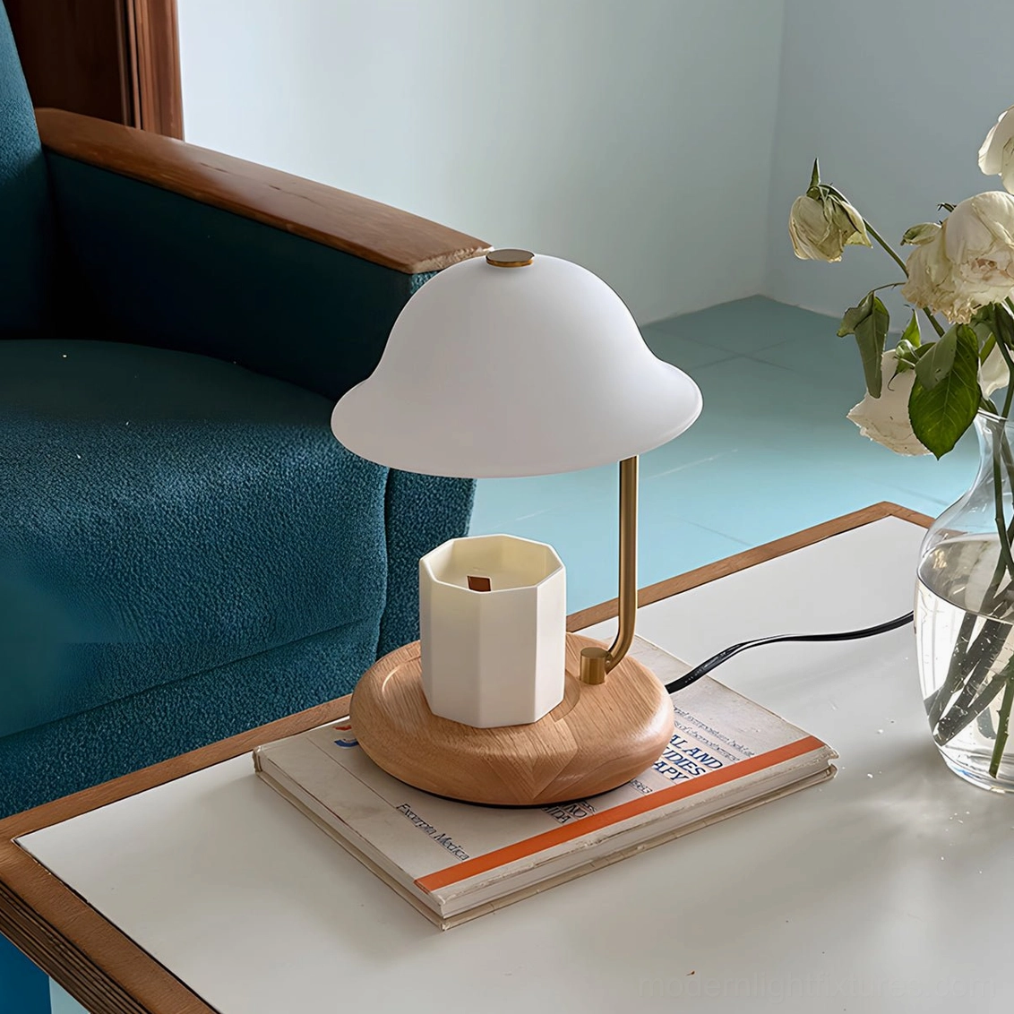 Contemporary candle warmer lamp with wood and metal design in warm interior setting with teal armchair