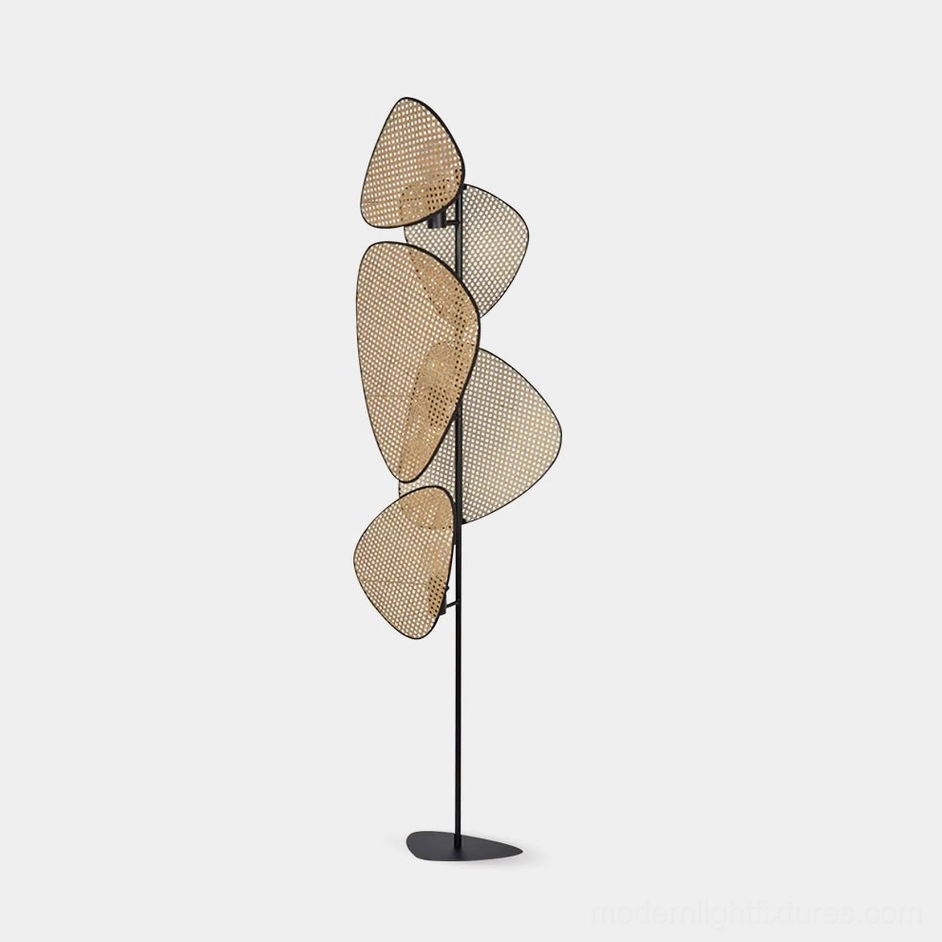 Cannage rattan floor lamp with perforated woven cane panels and black metal frame, front view on white background
