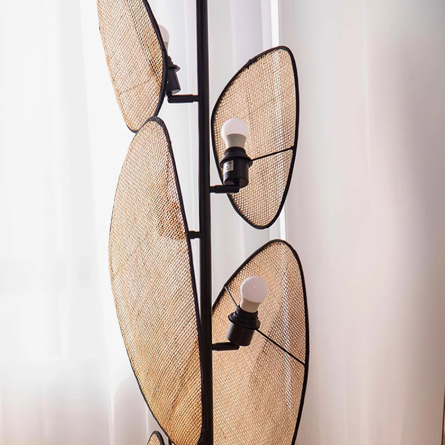 Cannage floor lamp with perforated panels highlighting geometric weave pattern and design craftsmanship