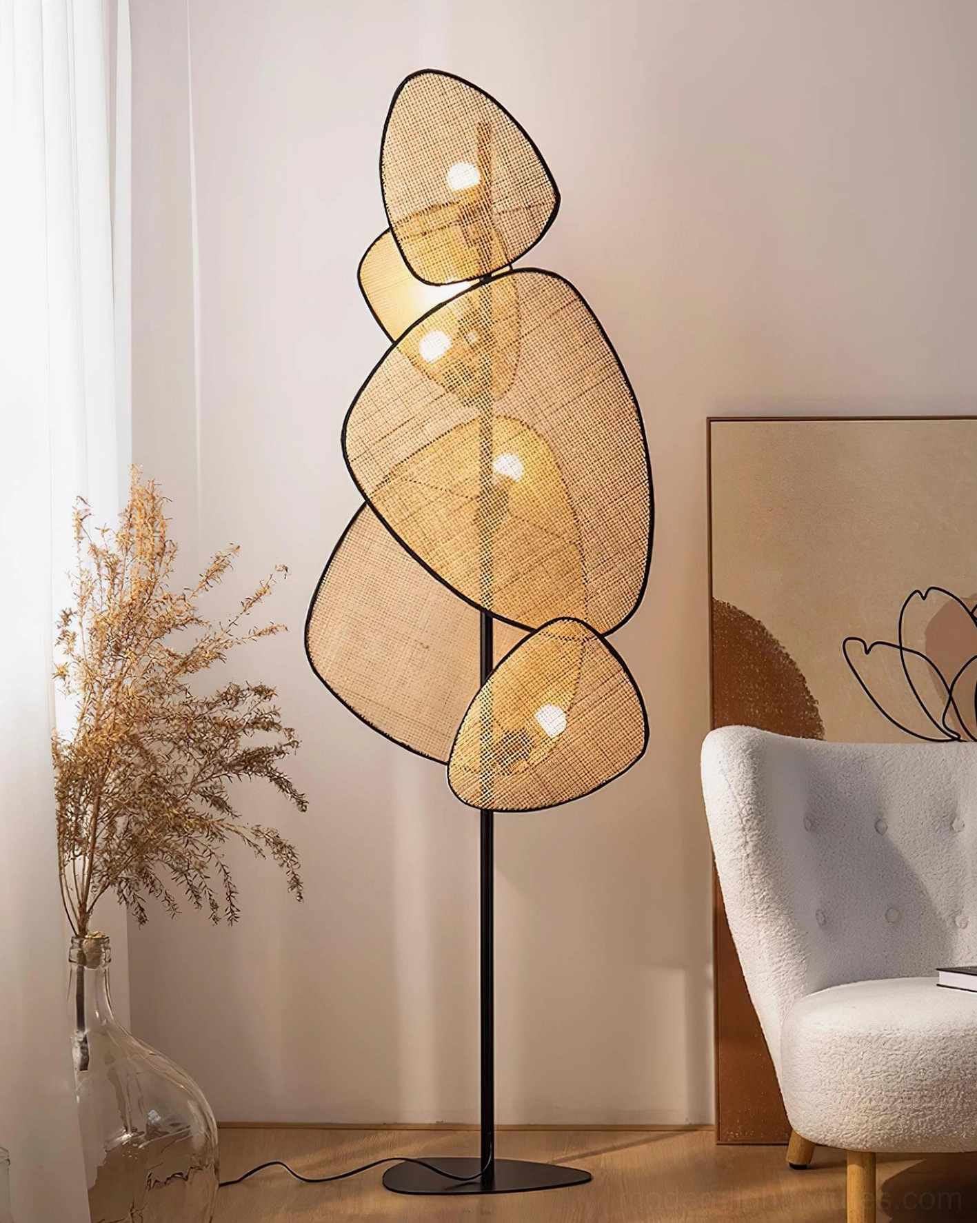 Cannage rattan floor lamp showing sculptural shadow play cast on wall surface