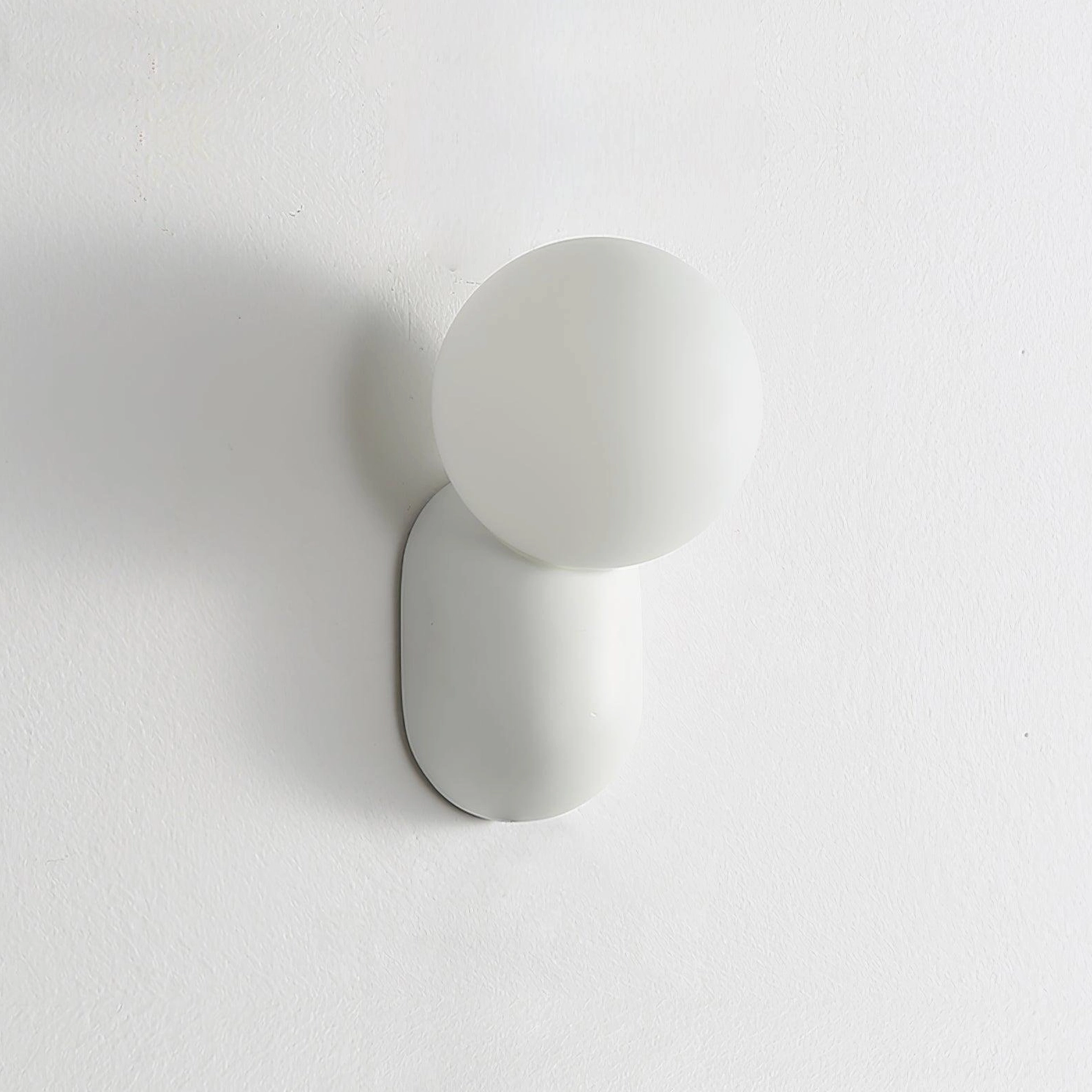 Cantilever wall sconce architectural installation, demonstrating angled arm light projection technique