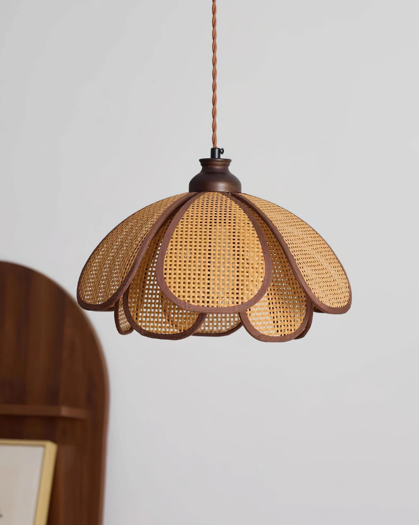 Capelina woven rattan petal pendant lamp showcasing organic botanical design and warm ambient glow
