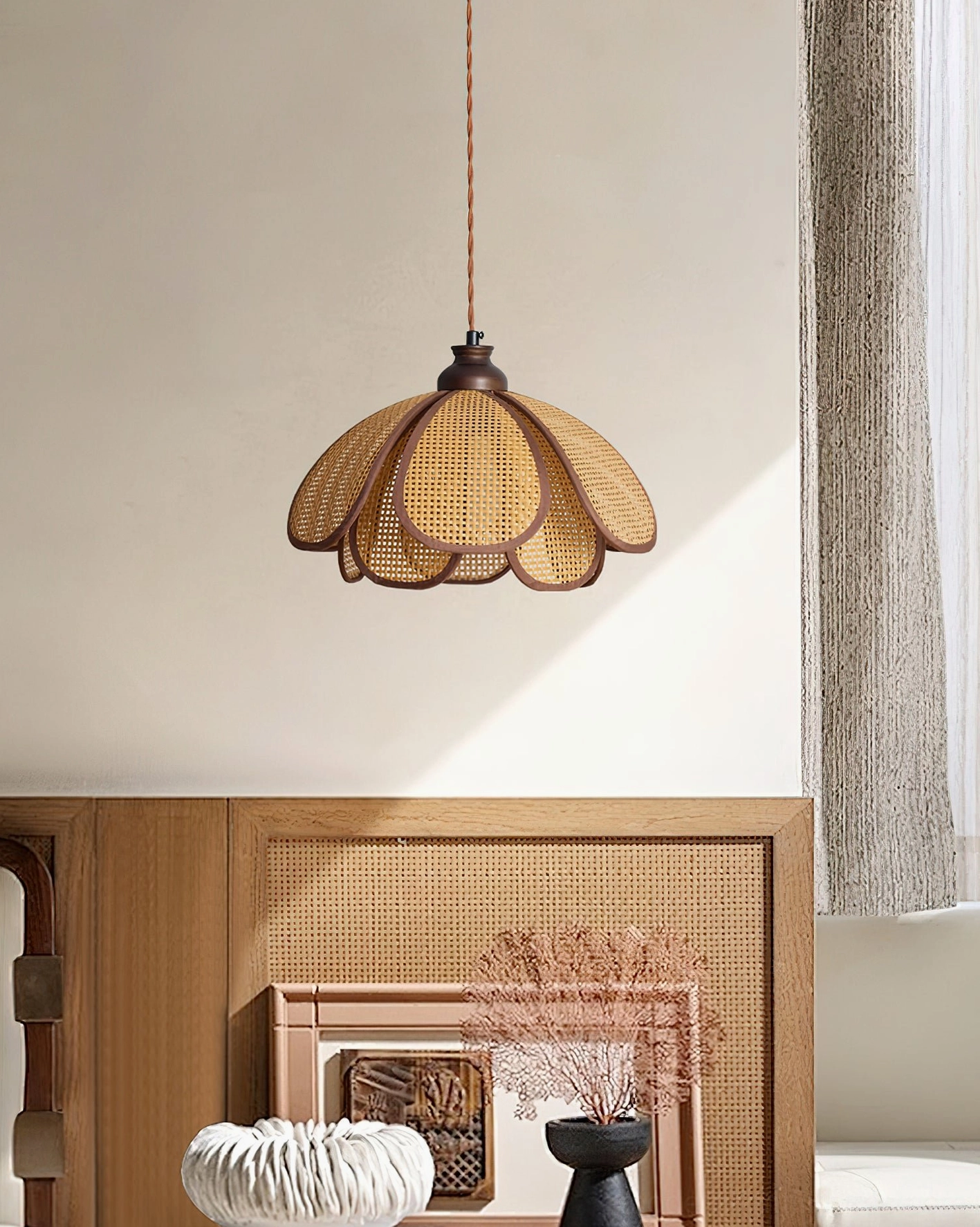 Capelina pendant light hung over wooden dining table in modern Japandi home interior with dried flower decor
