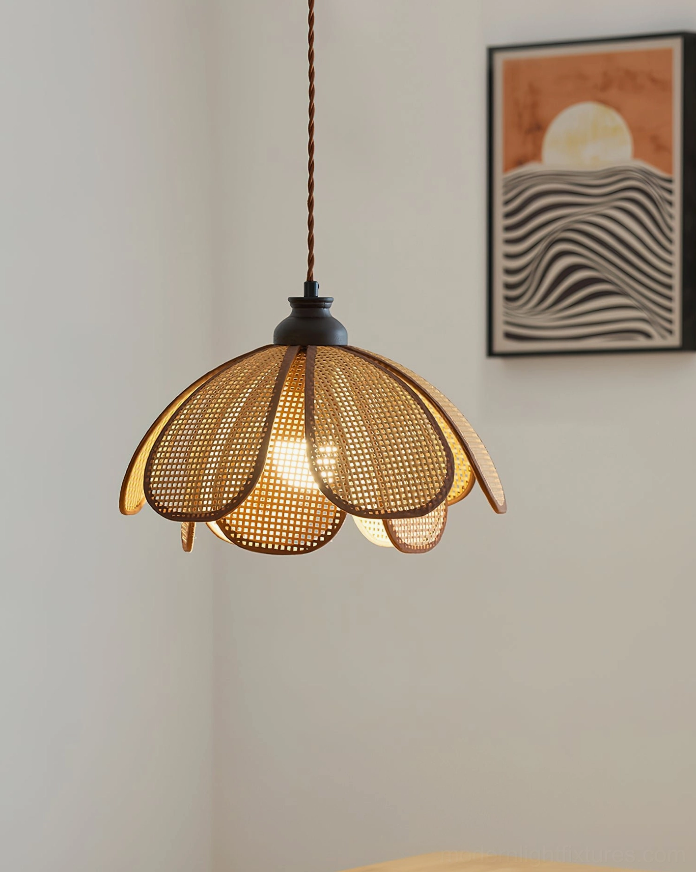 Natural woven rattan Capelina pendant lamp with minimalist wall art and botanical home styling